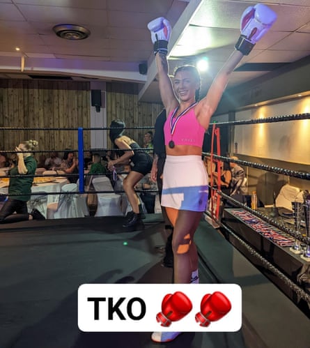 Women with arms up in arm, boxing gloves on