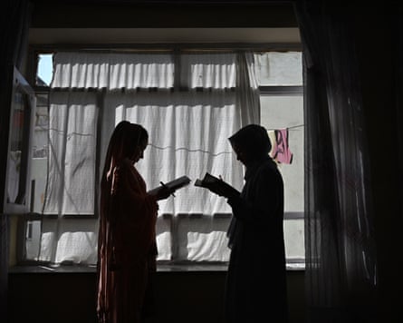Afghan girls attending a lesson given by their father at their residence in Kabul