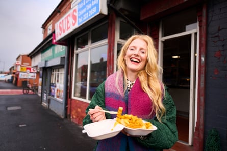 Newly elected MP Hannah Spencer enjoys chips and curry sauce from Sue’s chippy in her constituency.