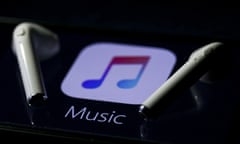 Apple Music logo on a smartphone and earphones