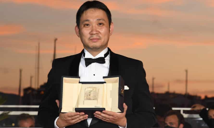 Ryusuke Hamaguchi with the his best screenplay award for Drive My Car in Cannes.