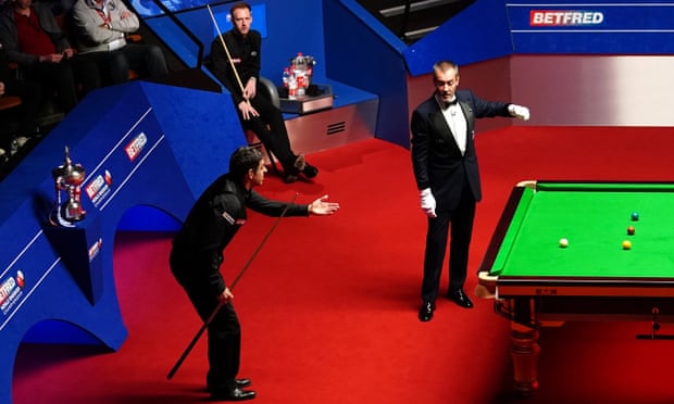 Ronnie O’Sullivan argues with Olivier Marteel as Judd Trump watches on.