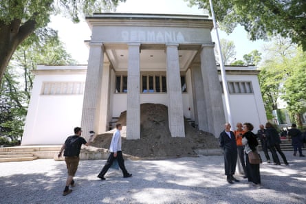 A mound of dirt with a story blocks the front entrance of the German pavilion.