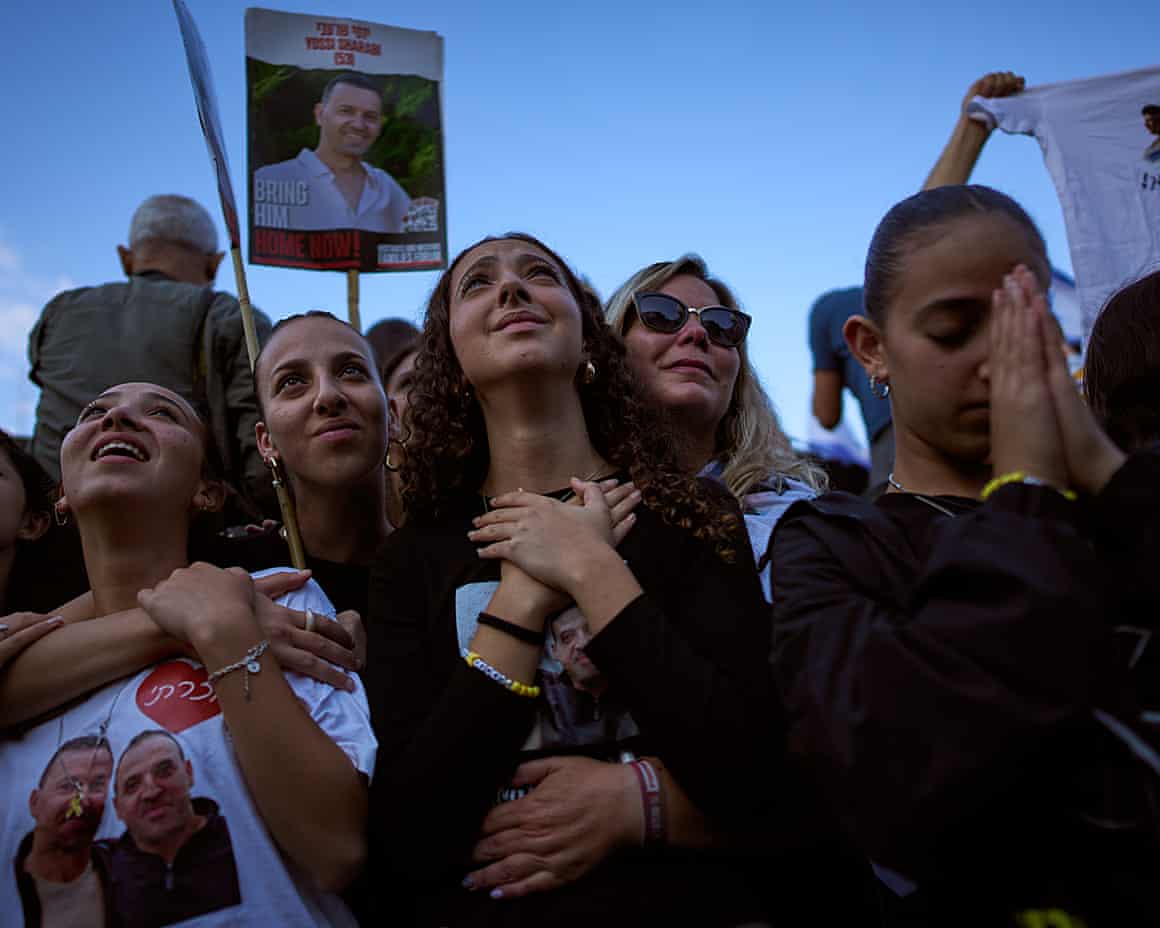 People watch a live broadcast of Israeli hostages released from Hamas captivity in the Gaza Strip