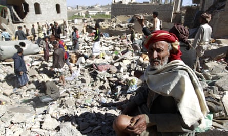 A Yemeni man sits on the rubble as people search for suvivors in houses destroyed by an overnight Saudi-led air strike on Sana’a.