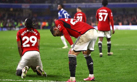 Manchester United’s players collapse to the ground in disappointment after losing to Chelsea