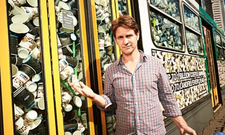 Craig Reucassel with a tram full of coffee cups in Melbourne.