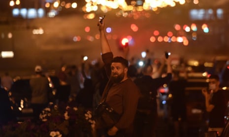 A man holding up a phone with a torch during a Minsk rally of opposition supporters, who accuse Lukashenko of falsifying the polls in the presidential election.