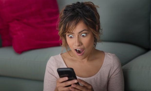 Woman surprised at message on smartphone