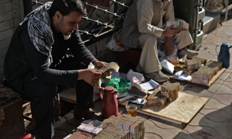 Afghan men count their money at a money market in Kabul 