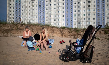 Women with a child on the beach by the Severnaya Dvina River in Severodvinsk, Russia