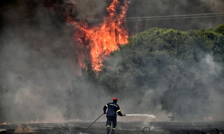 A firefighter facing a wildfire in Loutraki, Greece.