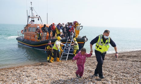 Border Force officers bring migrants ashore from a life boat at Dungeness in Kent earlier this month.