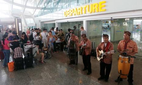 A group of musicians performs as they entertain passengers waiting for their delayed flights at Bali’s Ngurah Rai International airport on Saturday. 