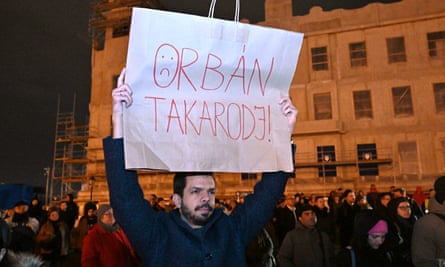 A protester with a placard reading ‘Orban: get out!’ at the presidential palace in Budapest, Hungary, 14 February 2024