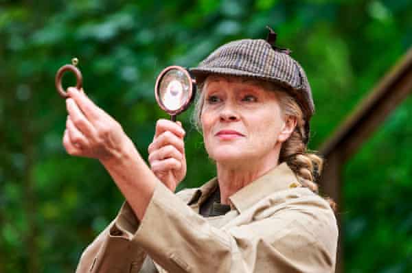 Deirdre Davis, holding up a magnifying glass to examine a curtain ring, in Sherlock Holmes: A Study in Lipstick, Ketchup and Blood.