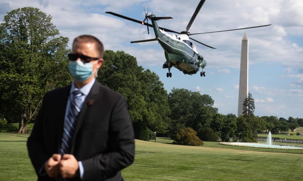 A US Secret Service agent stands by as Marine One, with Donald Trump aboard, departs the White House in July 2020.
