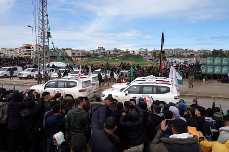 International Red Cross vehicles wait for Israeli hostages to be handed over by Hamas in Nuseirat, central Gaza Strip.