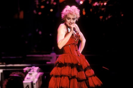 A woman wearing a flamenco dress holding a microphone