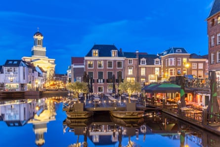 Canal and bright lights at dusk in Leiden