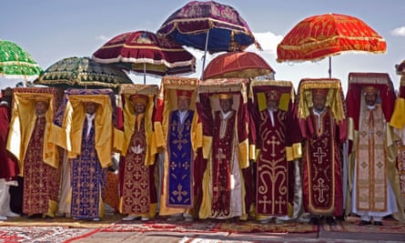 Ethiopian Orthodox priests in religious costumes carrying holds tabots above their heads