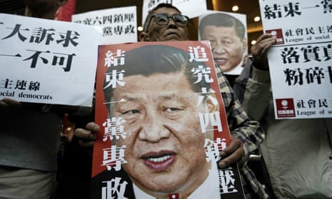 Pro-democracy activists hold up placards of Xi Jinping with slogans including ‘End one party state’ at a ferry terminal in Hong Kong.