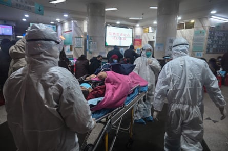 Medical staff wearing protective clothing to protect against a previously unknown coronavirus arrive with a patient at the Wuhan Red Cross Hospital in Wuhan. - The number of confirmed deaths from a viral outbreak in China has risen to 54, with authorities in hard-hit Hubei province on January 26 reporting 13 more fatalities and 323 new cases