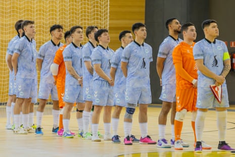 Greenland’s players turn to face their national flag before playing.