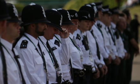 Police officers line up to observe a minute’s silence at the Wimbledon tennis championships.