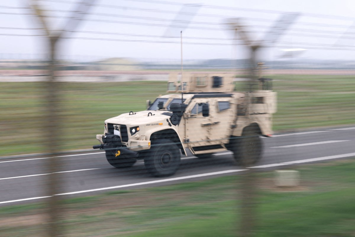 An LTV (light tactical vehicle) operates at the perimiter of the RAF Fairford airbase.