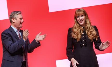 Keir Starmer applauds Angela Rayner onstage at the Labour conference