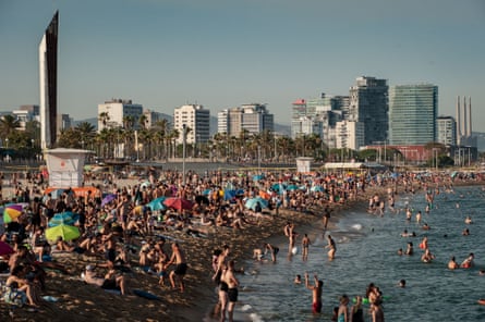 Tourists crowd Bogatell beach in Barcelona