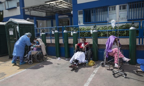 People infected with Covid-19 wait for an available bed outside a public hospital in Lima, Peru, Thursday, 30 April 2020.
