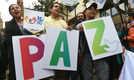 People hold signs forming the word 'peace' in Bogota, July 2016