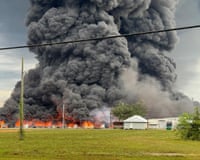 large amount of smoke rises in air below fire outside