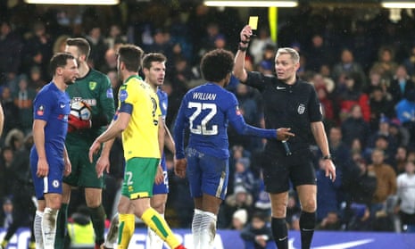 Chelsea’s Willian is shown a yellow card by Graham Scott for diving in the penalty area.