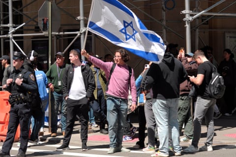 A pro-Israel protester waves an Israeli flag