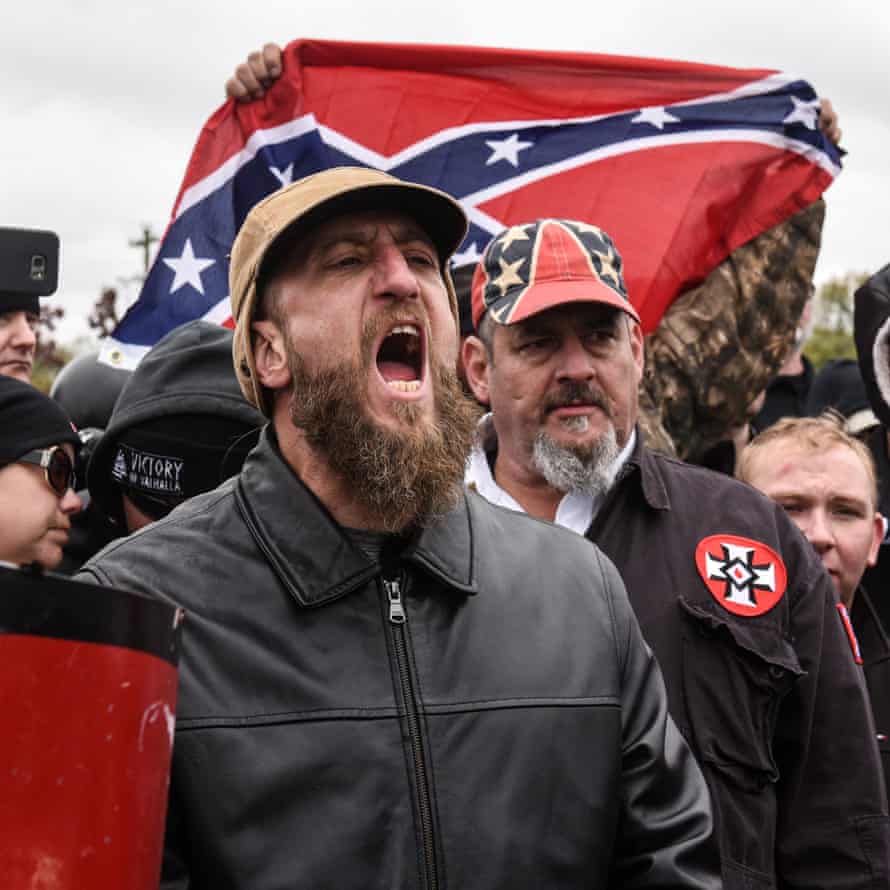 A demonstrator holds up a Confederate flag at a White Lives Matter rally in Shelbyville, Tennessee, on 28 October