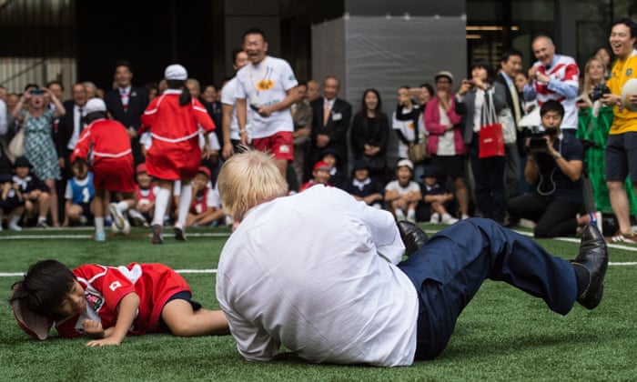 Boris Johnson Knocks Over 10 Year Old During Rugby Game In Japan Politics The Guardian
