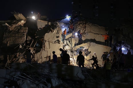 Emergency services work at the site of a collapsed building in Caracas