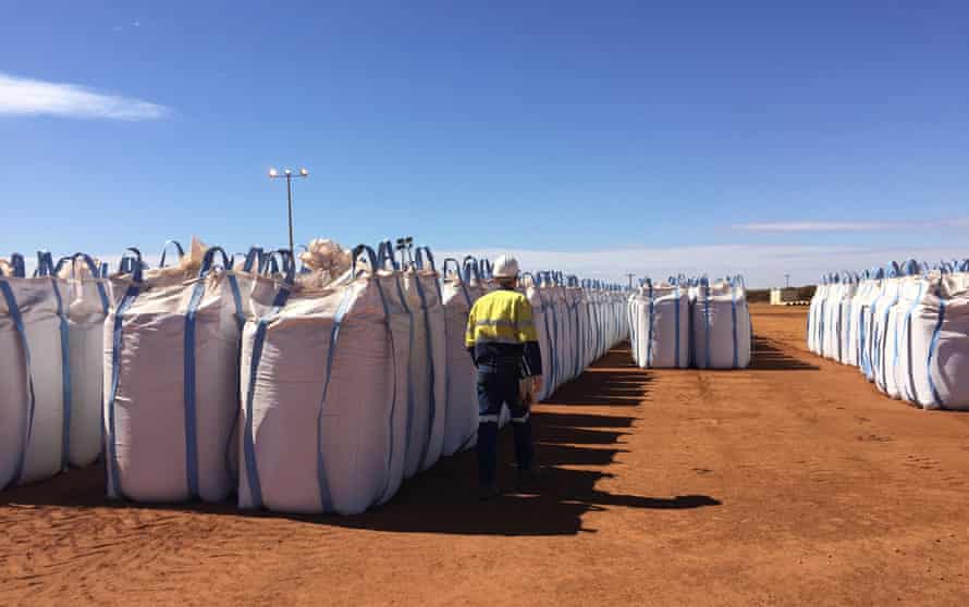 A Lynas Corp worker walks past sacks of rare earths waiting to be shipped to Malaysia in 2019.