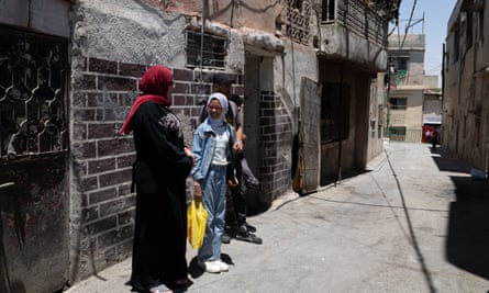 People standing in an alleyway in Wehdat, Amman