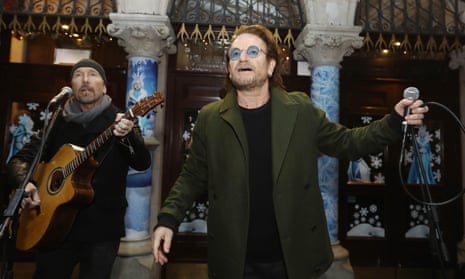 The Edge (left) and Bono busking in Dublin in 2018.