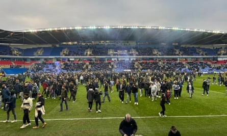 Reading fans invade the pitch during the League One match against Port Vale.
