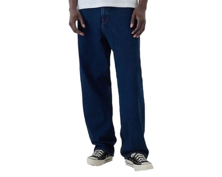 A cropped at waist image of a model wearing Gap indigo blue loose fit jeans