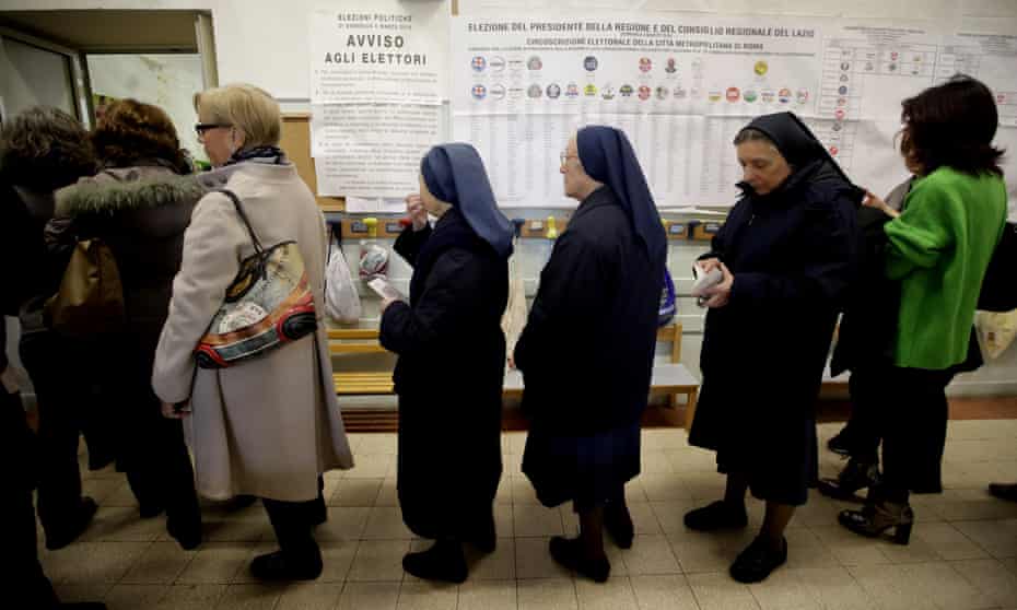 People lining up to vote at a polling station in Rome.