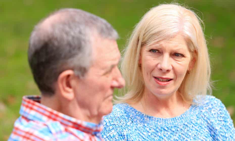 Close view of senior couple having a serious conversation. The focus is on the woman who is talking to the senior man. She looks concerned and worried. On the left, the man is in soft focus and looking away. They are casually dressed. Only head and shoulders are visible.
