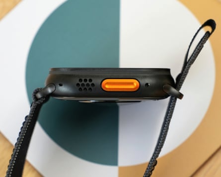 The orange action button in the side of the Apple Watch Ultra 3 in black.