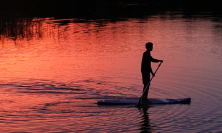 Stand-up paddleboarding is popular with the family