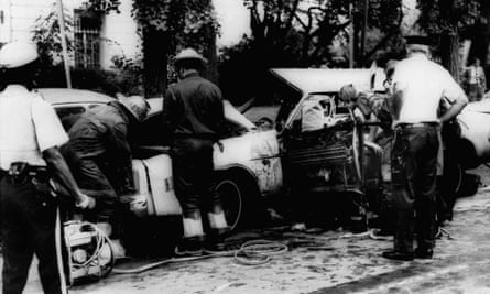 Firemen remove victims from Orlando Letelier’s shattered car shattered in Washington on 21 September 1976.